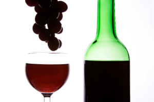 Red wine and grapes in wihte background.